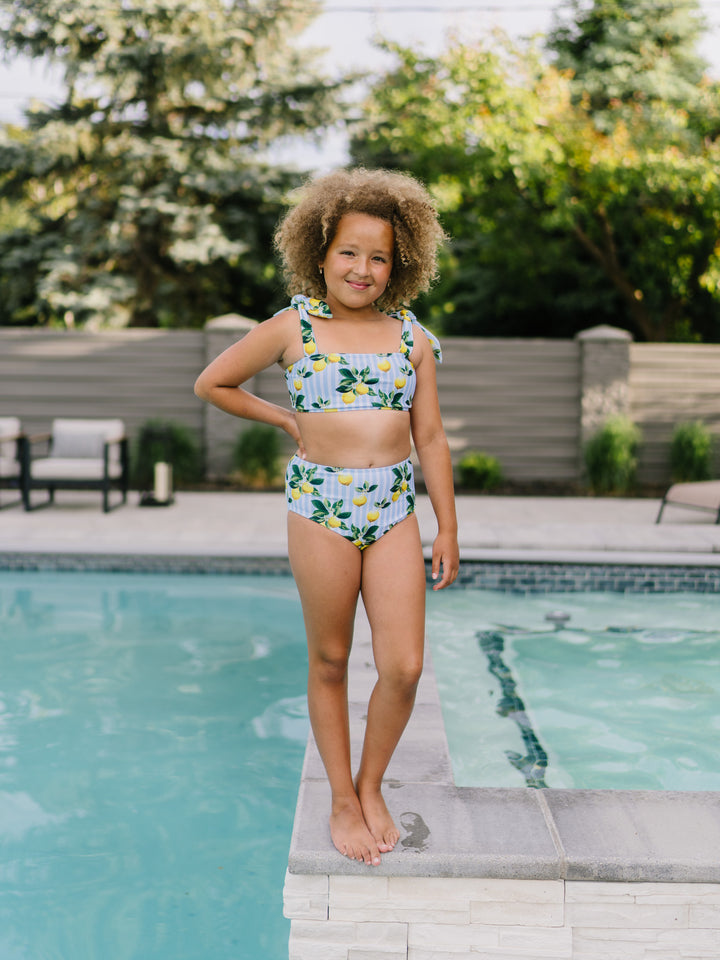 Navalora Swim Girl's Amalfi Coast Inspired Lemon Tie Top Bikini Swimsuit with Adjustable Ties, Girl Standing By the Pool 
